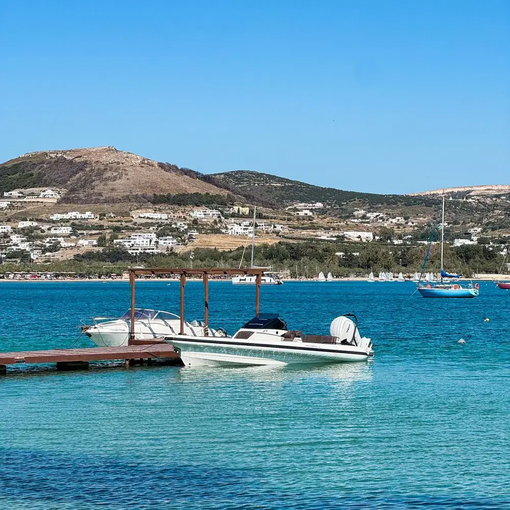 Motor yacht at a wooden pier in the Cyclades